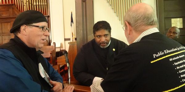 Dr. Jesse Turner at a government building advocating for public education